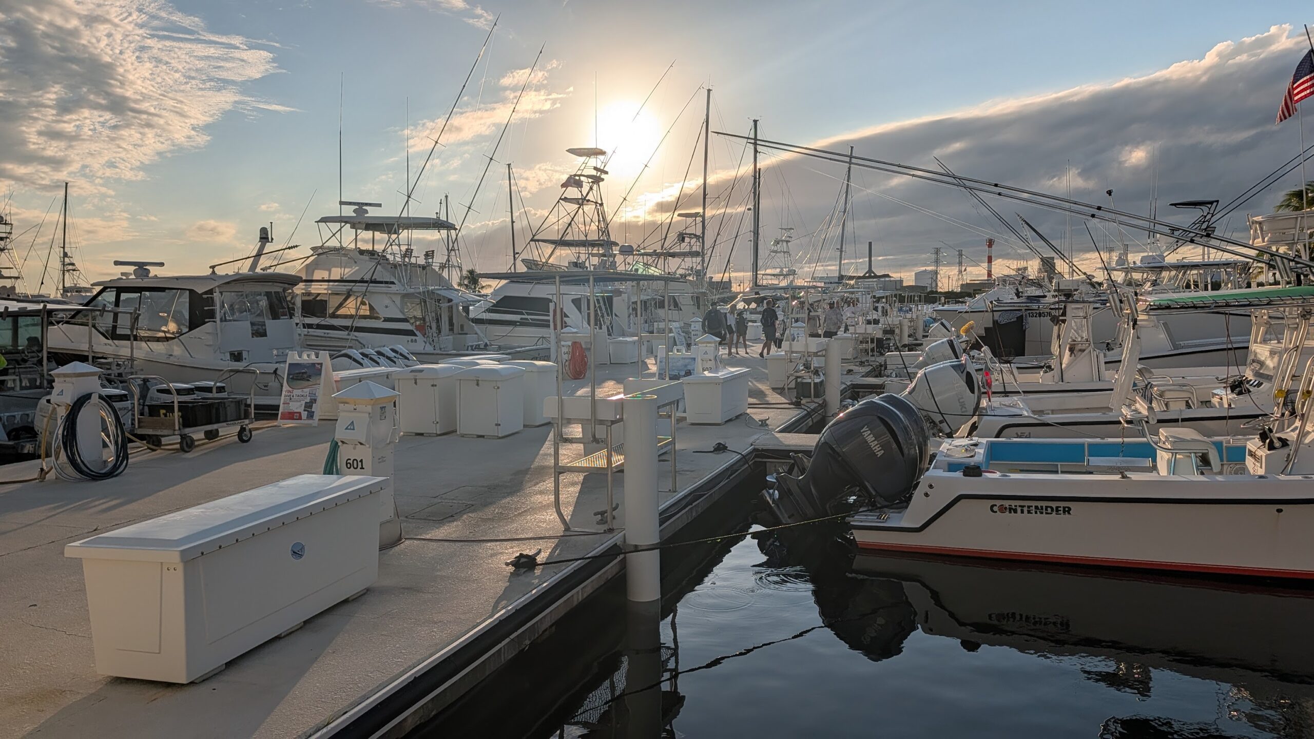 Boats moored in a harbor at sunset
