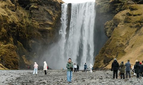 Sarah Joseph standing in front of waterfalls in Iceland
