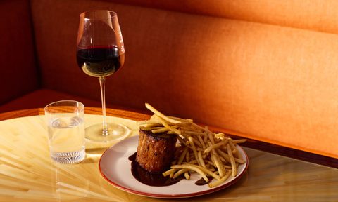 swordfish frites on plate with glass or wine