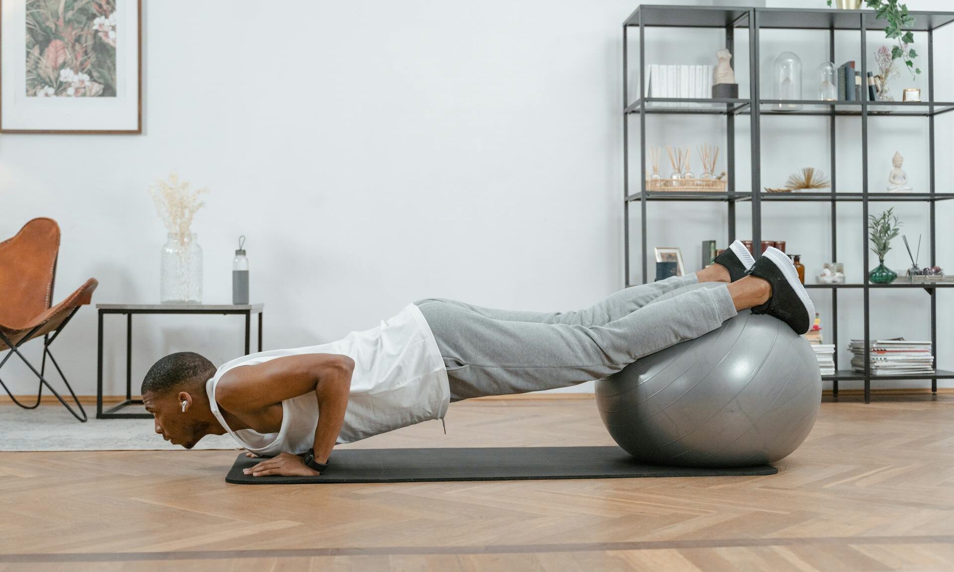 man doing incline push up on a Swiss exercise ball