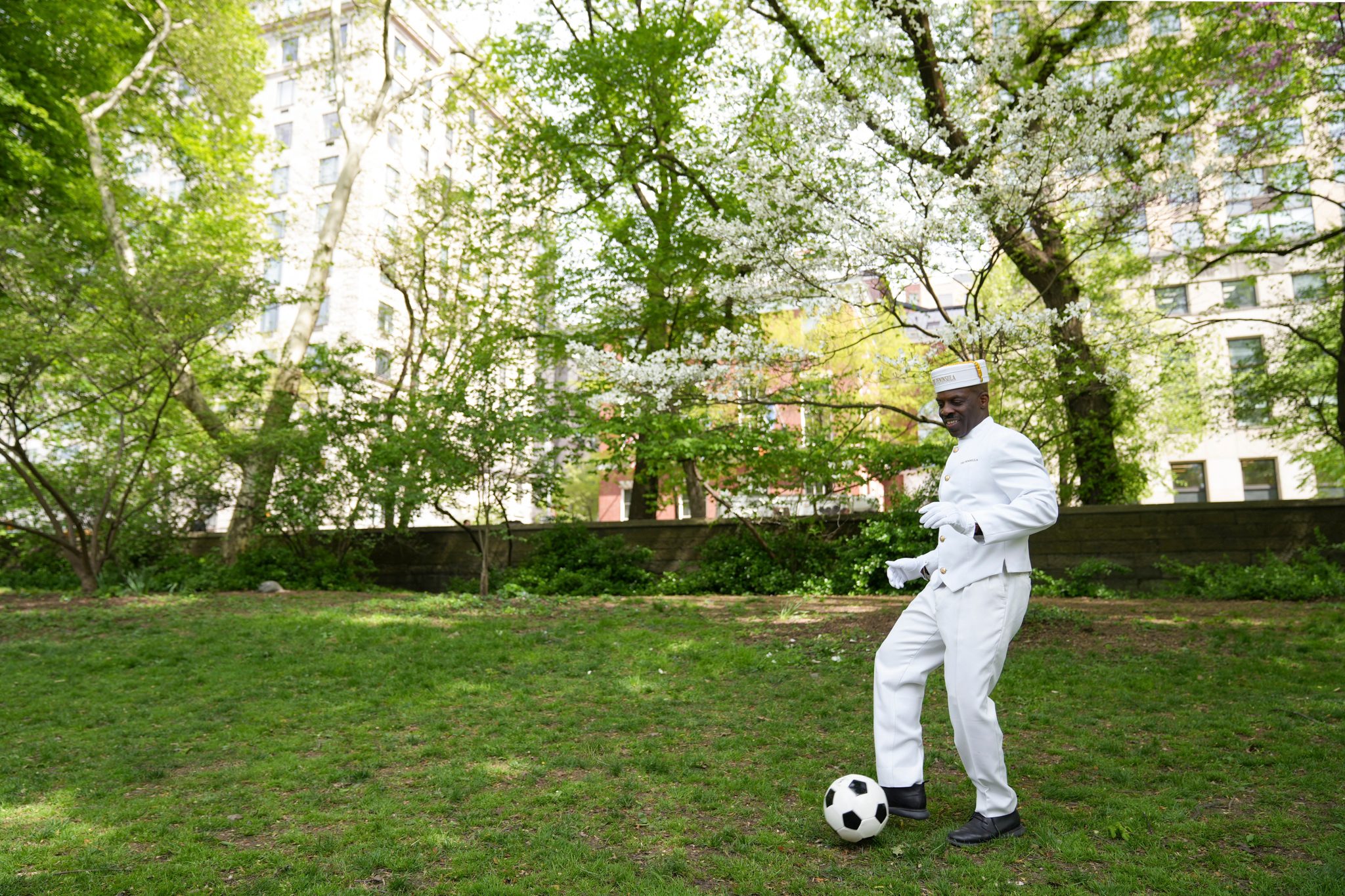 A member of the Peninsula Hotel Staff playing football