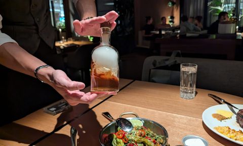 The waiter at Las Vegas' BOA Steakhouse presents a bottle of smoked old fashioned