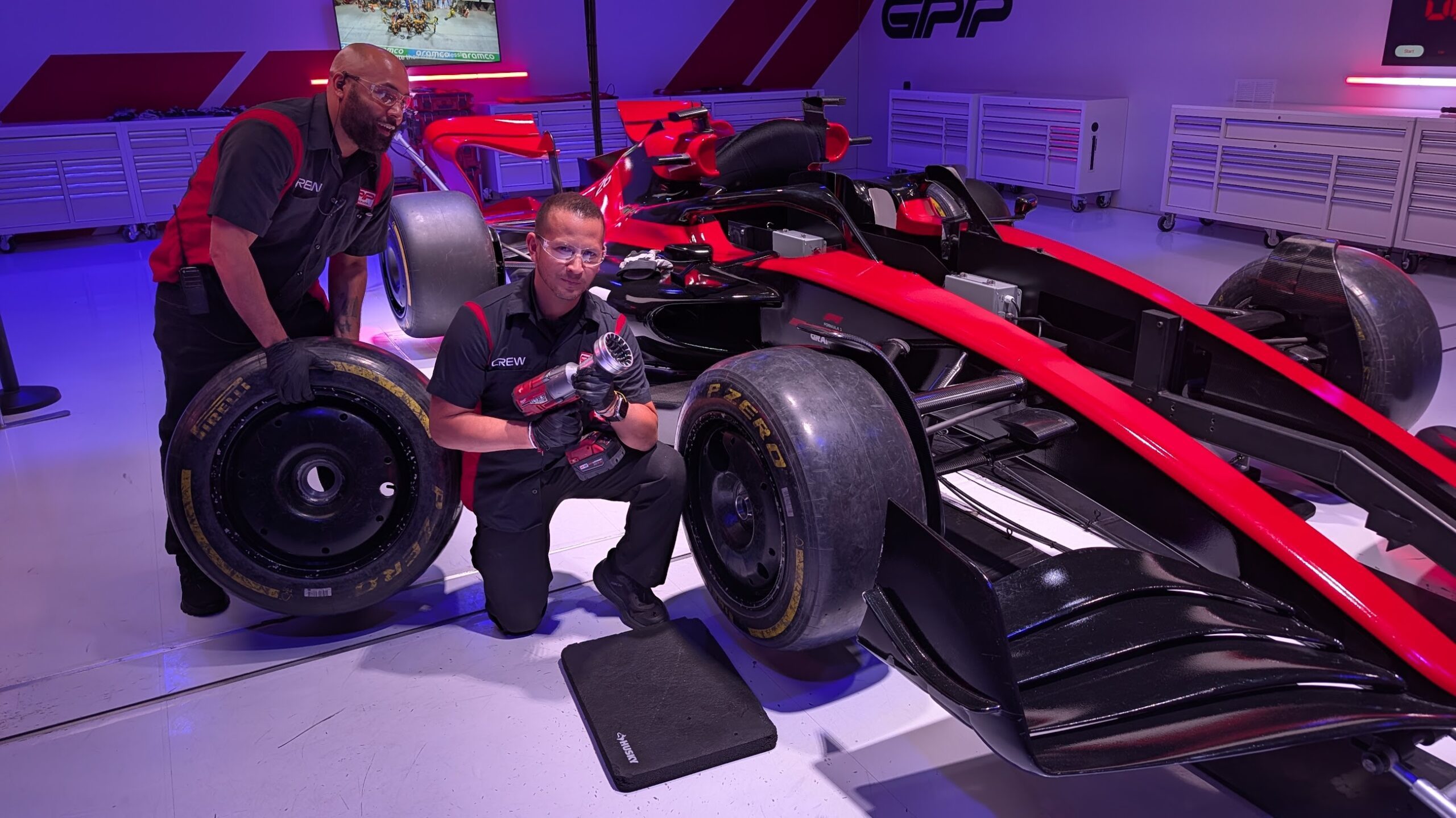 Two people changing a tire at F1 X in Las Vegas