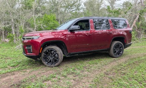 A side view of a red 2026 Jeep Grand Wagoneer off-road