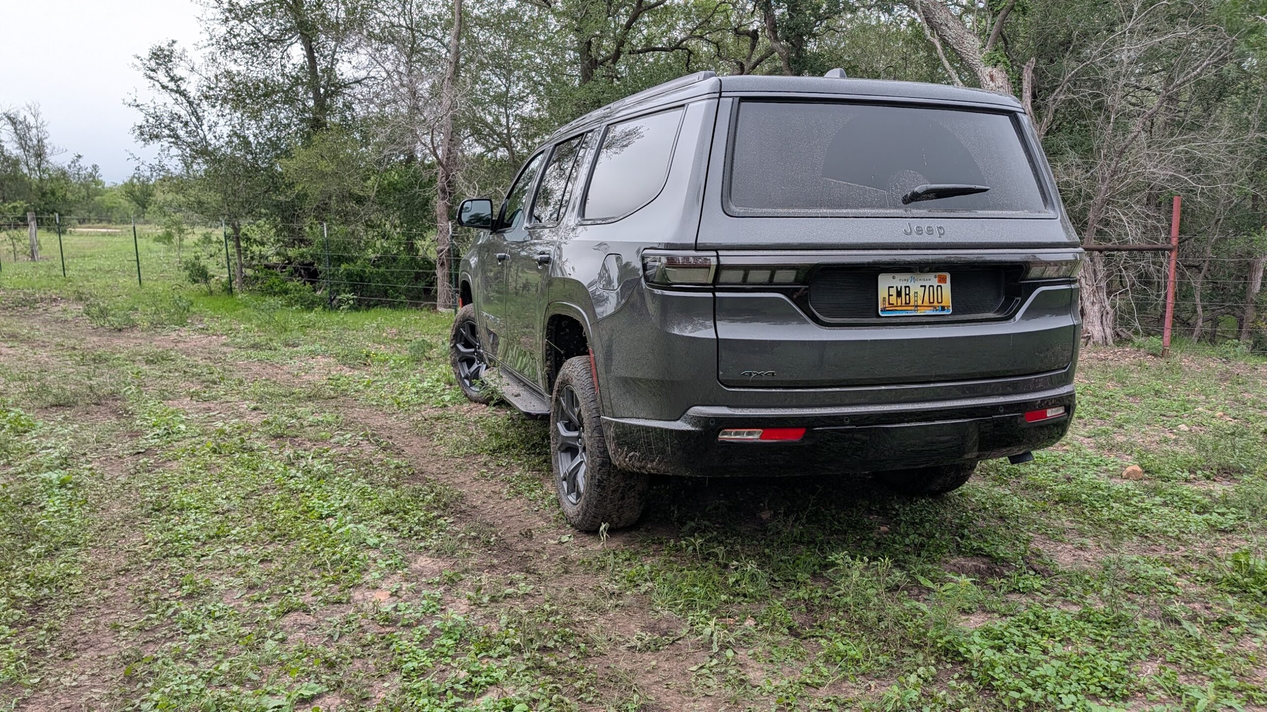A rear view of a gray 2026 Jeep Grand Wagoneer off-road