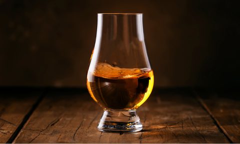 Scotch Whiskey without ice in glass, rustic wood