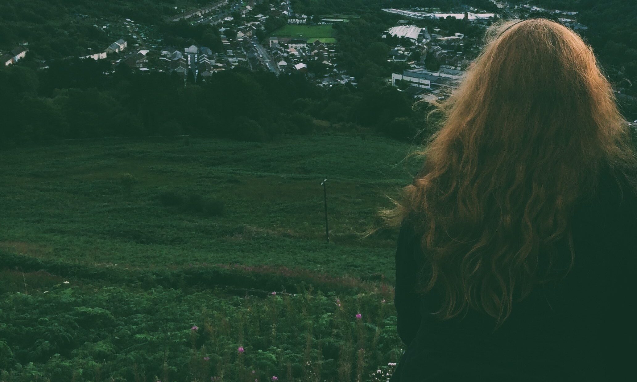 Steph sitting looking out at the Welsh valleys