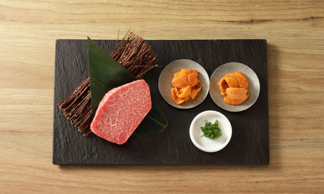 filet with uni on black plate