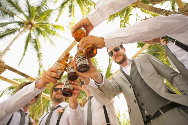 what to wear bachelor party guys doing a toast with beers