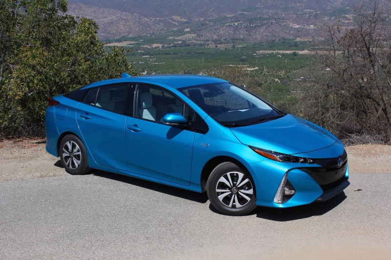 Blue shimmer 2017 Toyota Prius Prime parked on a mountain road.