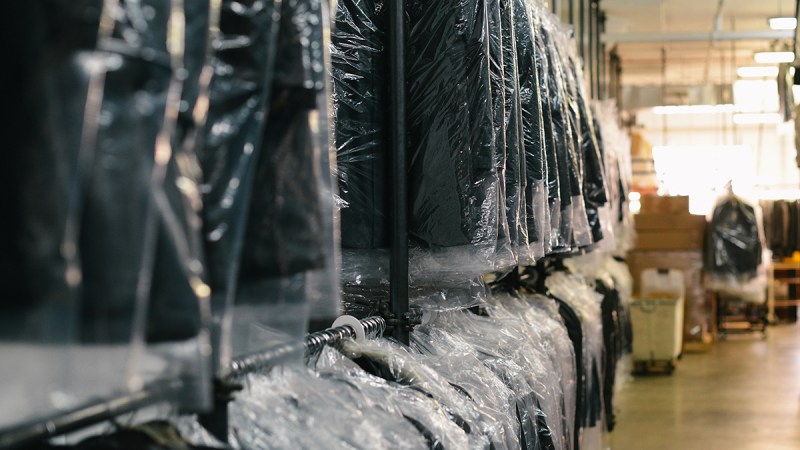 Garments hanging on dry cleaning racks