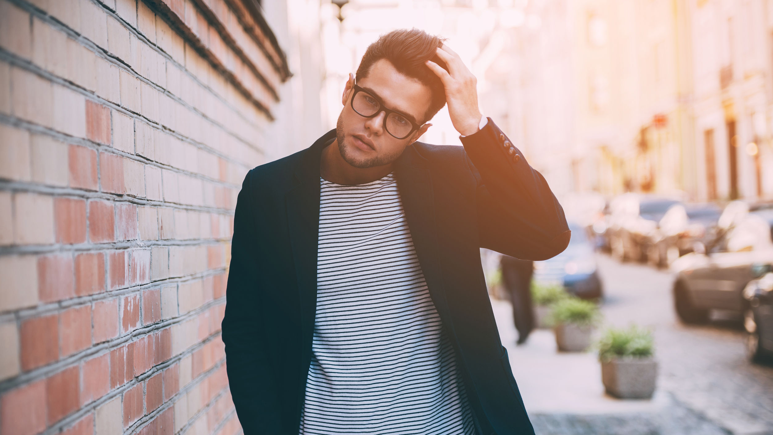Man in glasses, a blazer, and a T-shirt