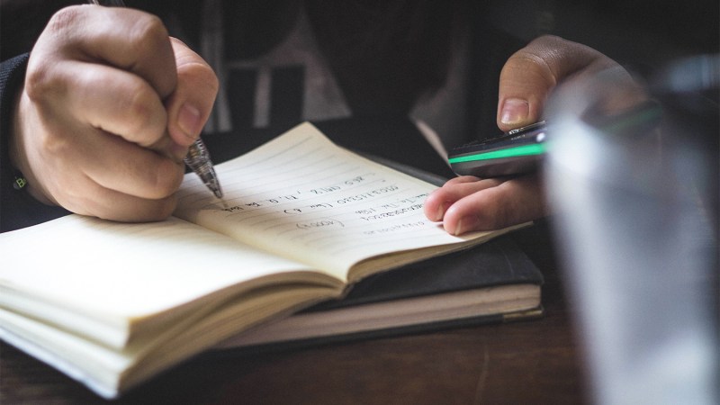 old school travel journal man taking notes