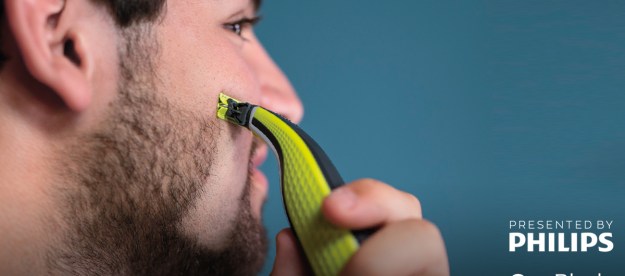 philips OneBlade razor in use against blue background