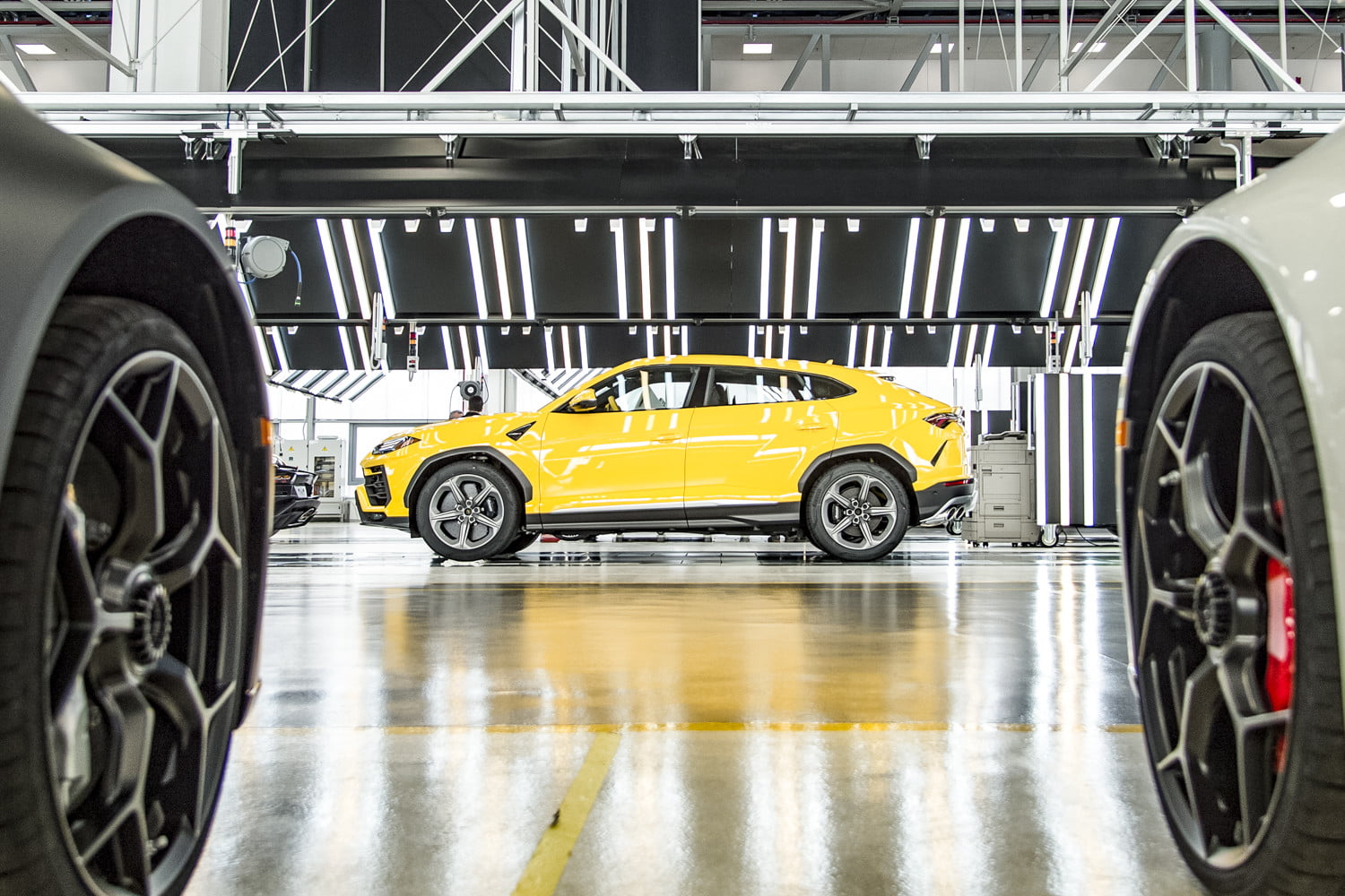 Lamborghini Urus in the automaker's factory positioned under bright lights.