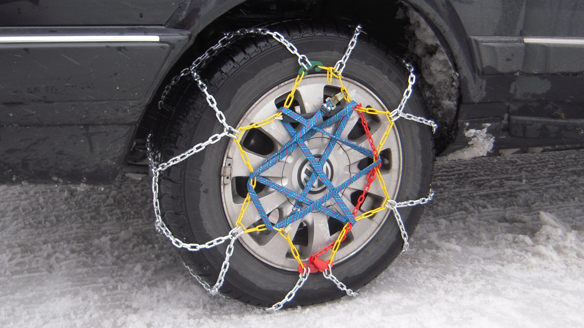 Elastic mounted snow chains on a car.