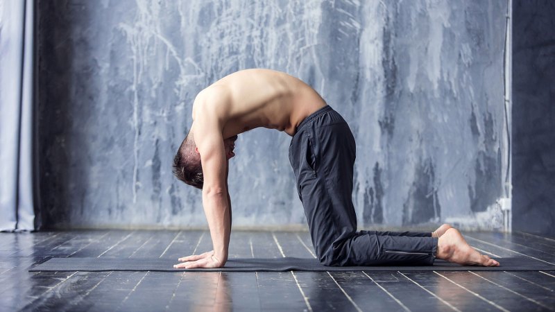 Man in cat cow yoga pose