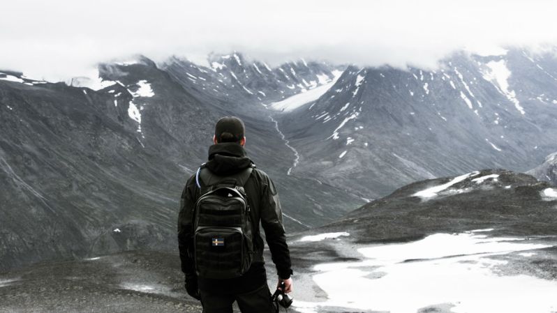 man backpack snow mountain