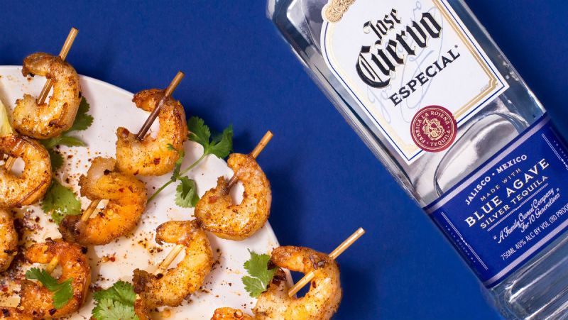 Jose Cuervo tequila with a plate of shrimps on the side.