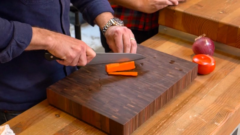 Cutting carrots on a cutting board