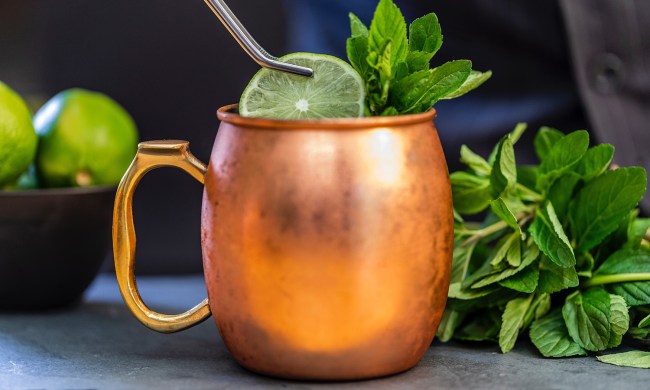 Moscow mule cocktail with lime and mint in a copper mug
