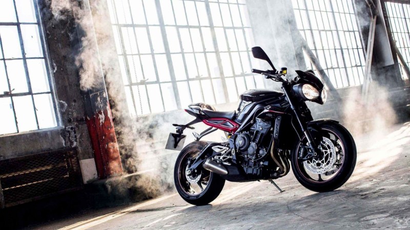 Front end angle of Triumph Street Triple Series R in a warehouse with smoke coming off the ground.
