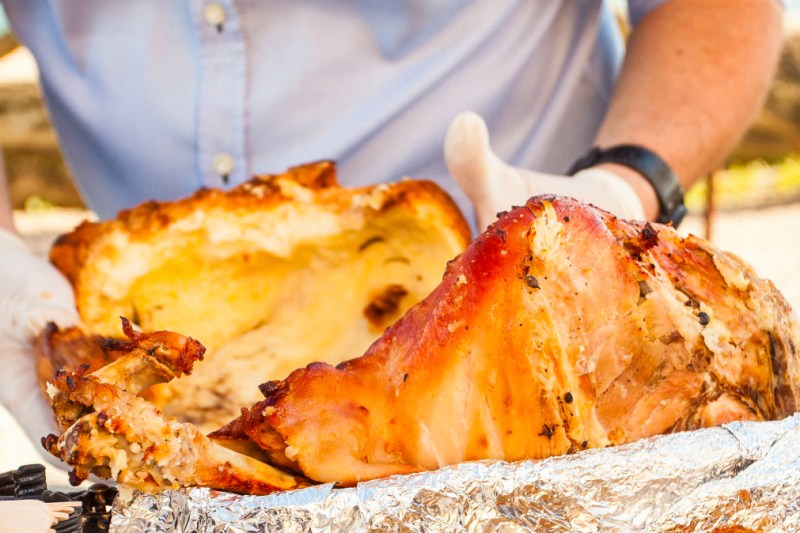 Cooking a ham over fire