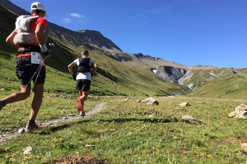 Two runners racing on foot through the French Alps.