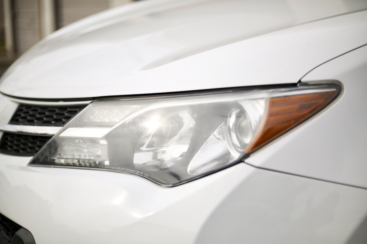 Foggy headlight on Toyota RAV4 from driver's side.