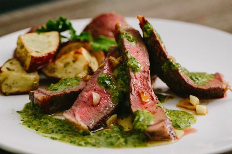 Ribeye Steak Roasted Potatoes with Chimichurri Sauce served on a plate.