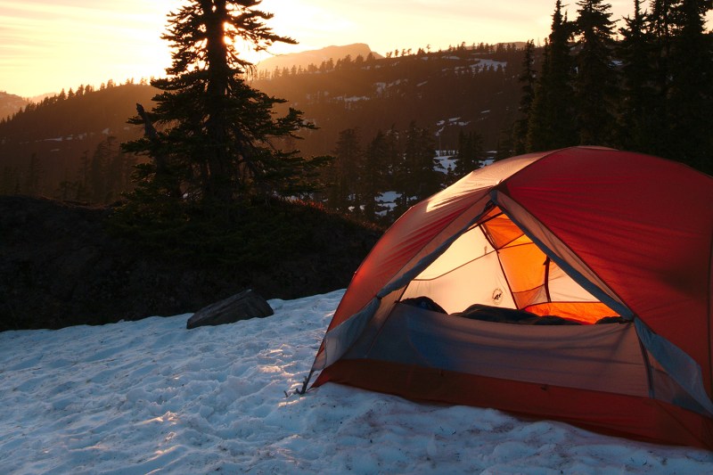 winter camping tent snow sunrise