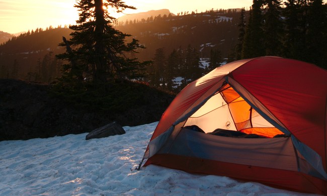 winter camping tent snow sunrise