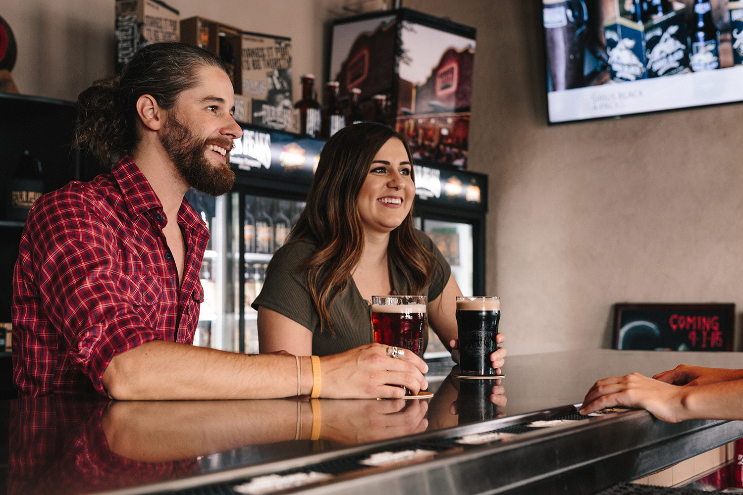 A couple enjoying beer served in nonic pint glasses.