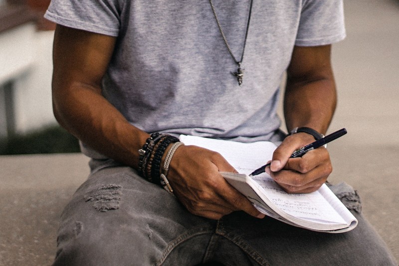 Man writing in a notebook