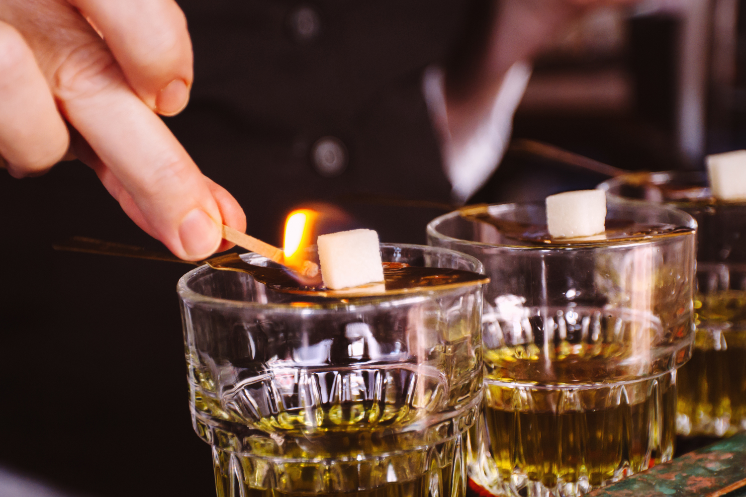 Bartender preparing absinthe at a bar