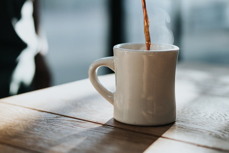 Pouring a cup of coffee.