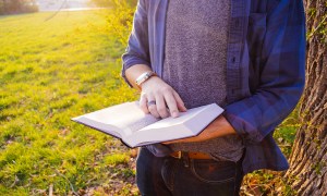 best business books man reading a book outside