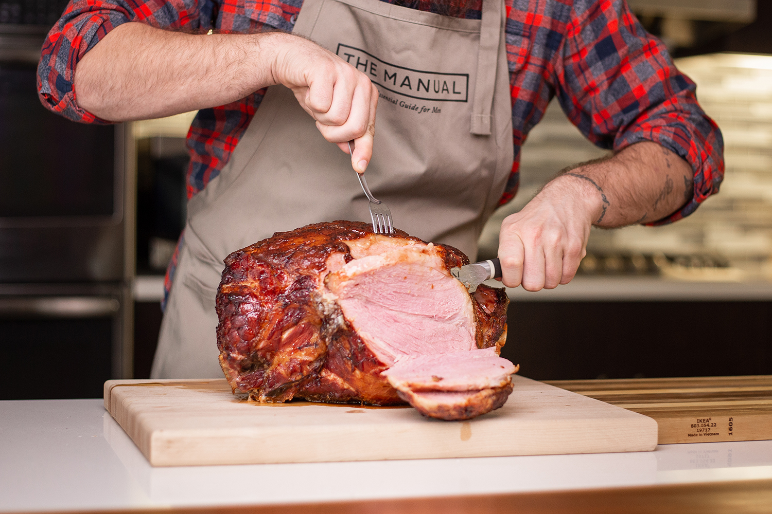 Man cutting ham in the kitchen