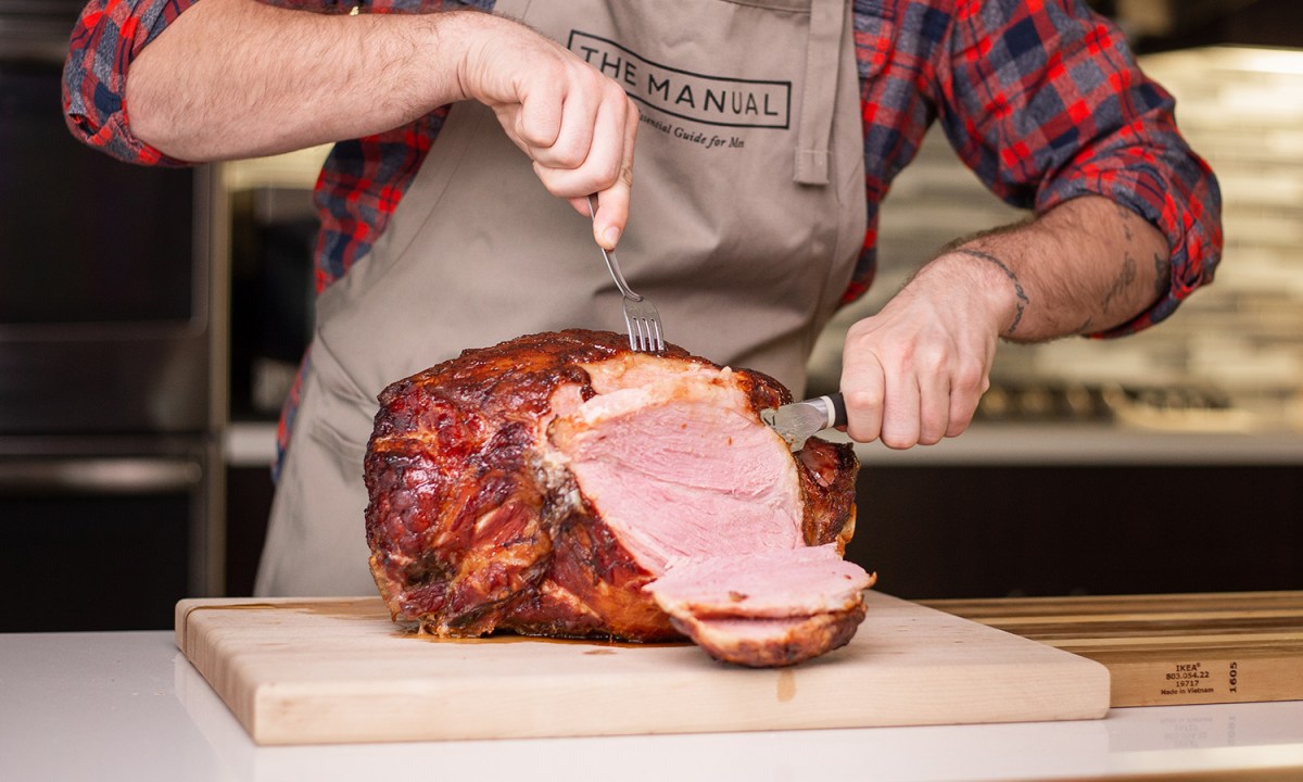 Man cutting ham in the kitchen