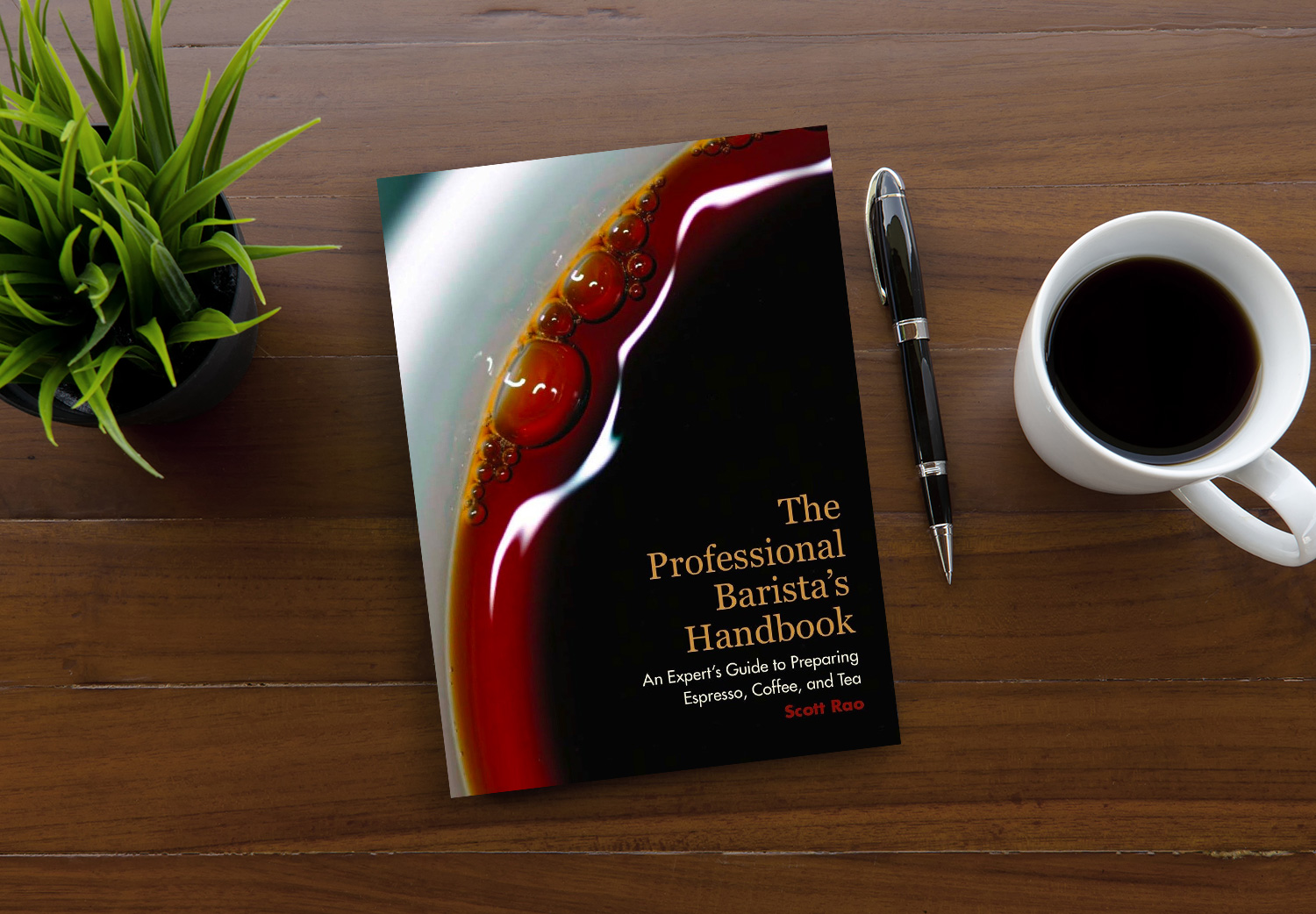 The Professional Barista's Handbook by Scott Rao on a wooden table.