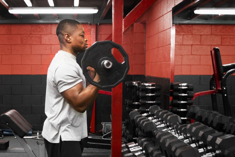 Man performing EZ bar curls