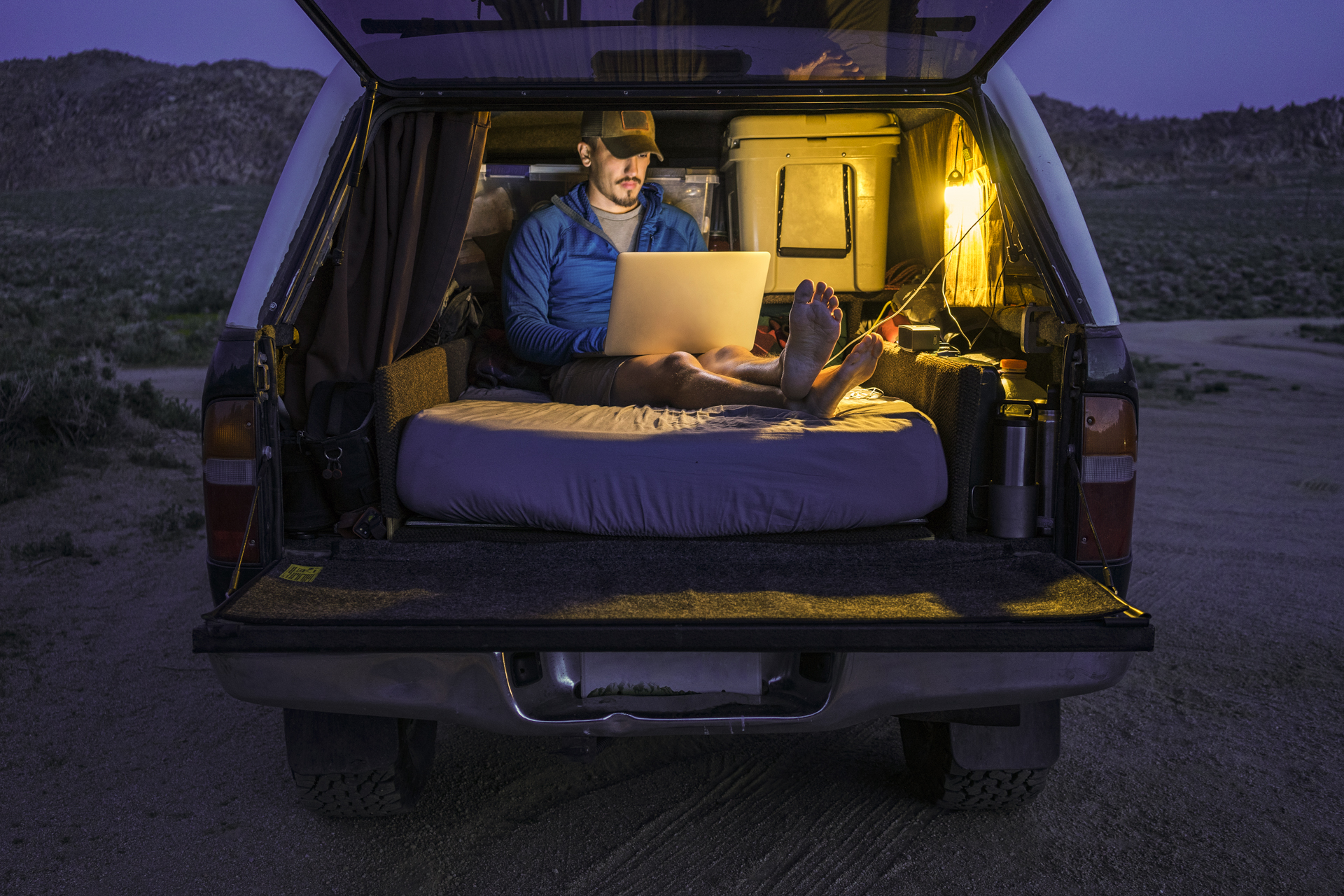 Relaxing in the back of a car on a mattress