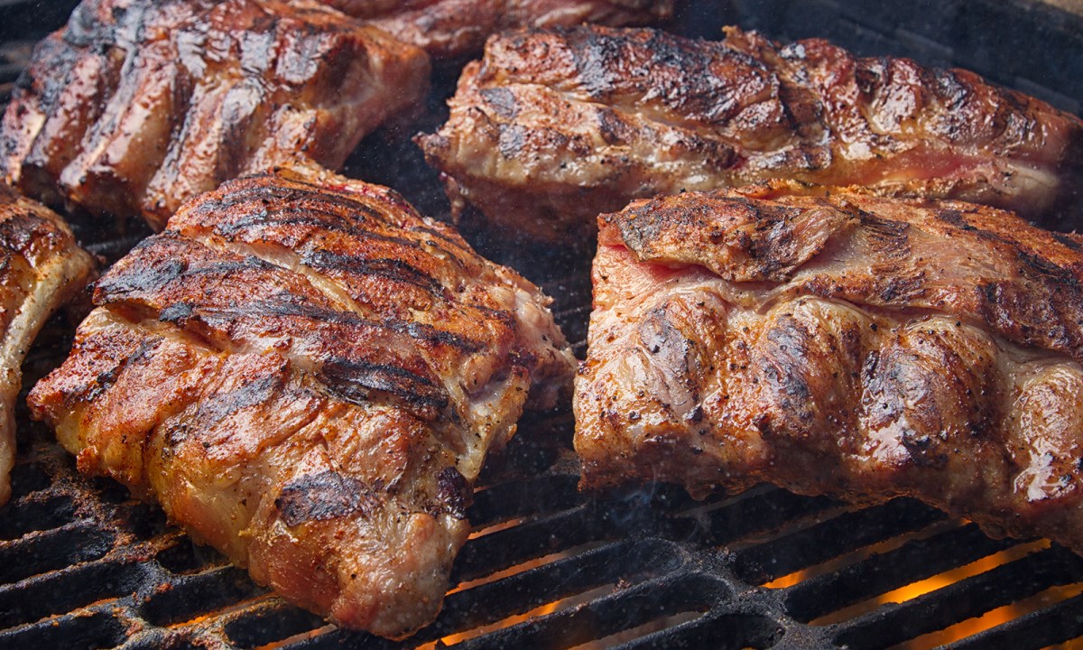 Pork ribs grilling on a barbecue