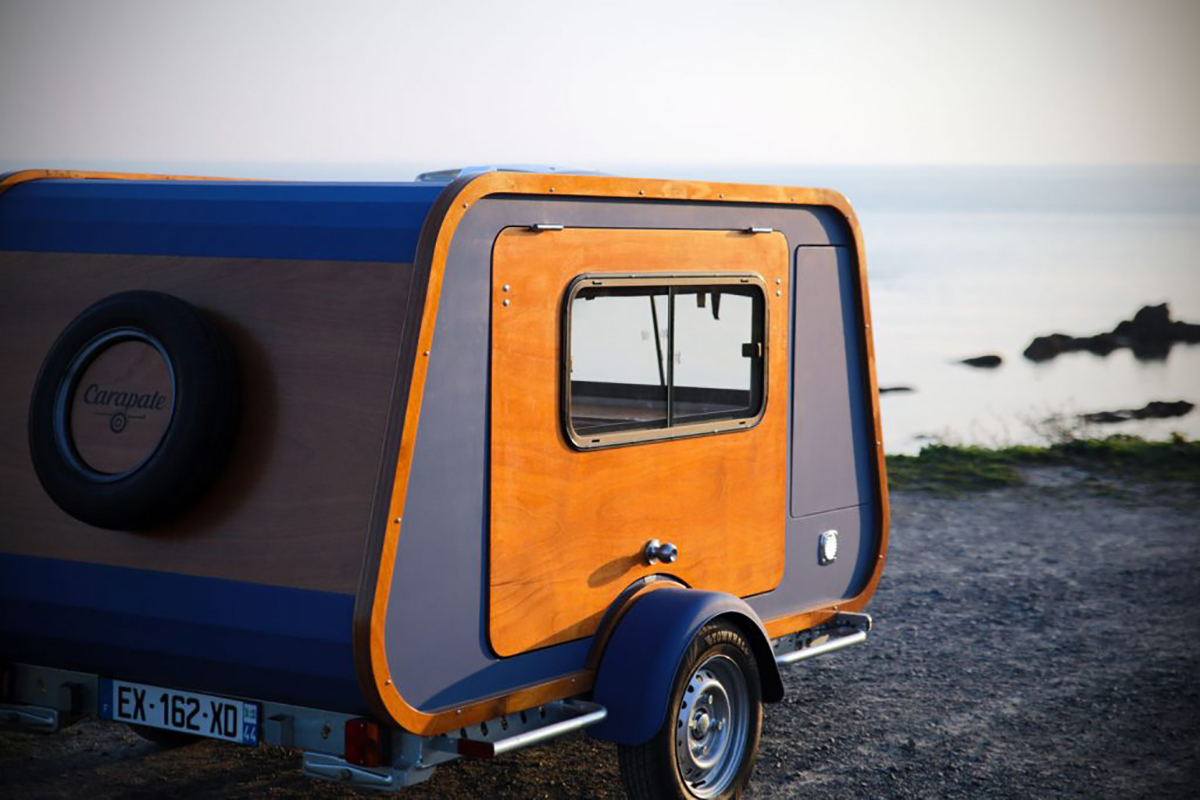 Carapate travel trailer parked on the beach.