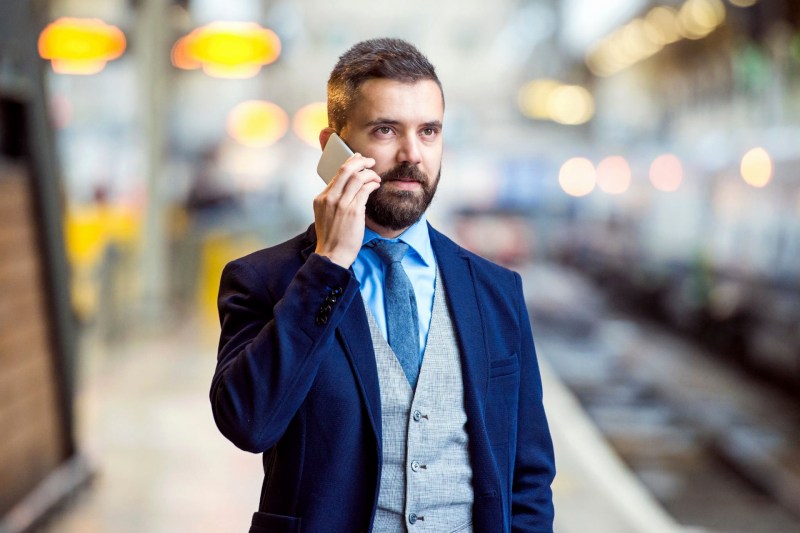Man wearing a suit talking on the phone