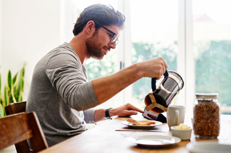 Man pouring coffee from a French press