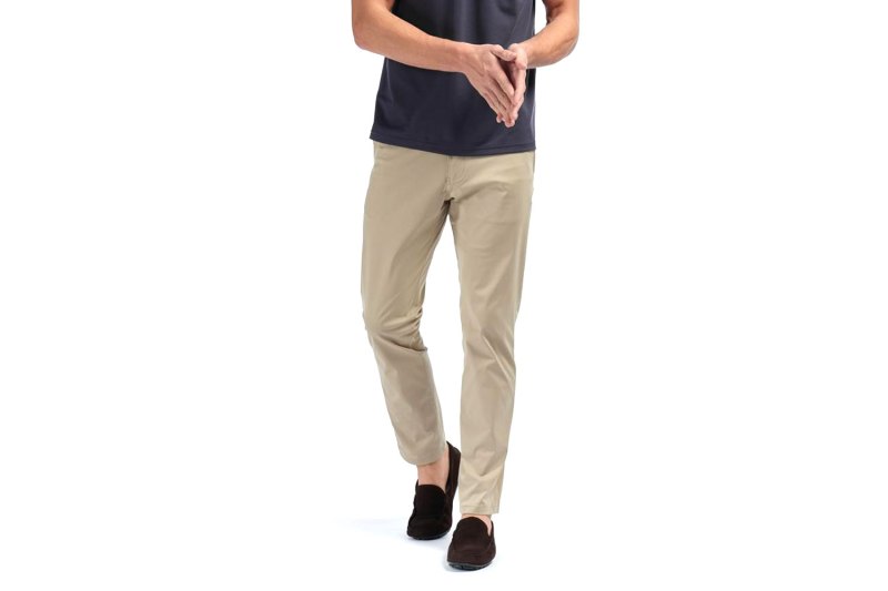 Rhone Commuter pants in khaki over a white background.