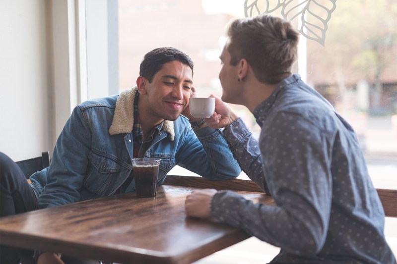 Young gay couple in coffee house