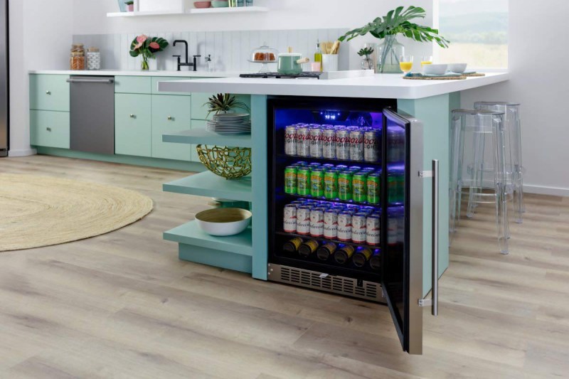 a beverage cooler placed under a kitchen countertop.