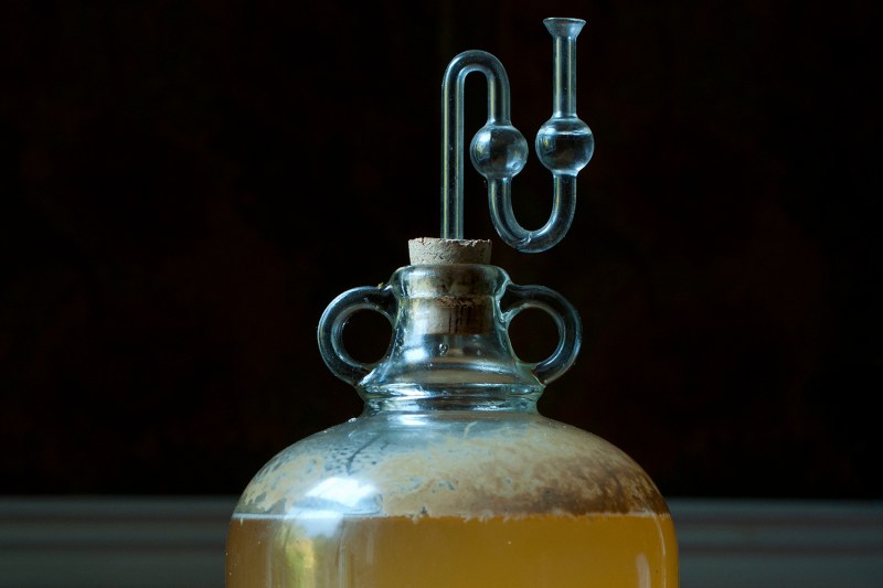 A large bottle of apple cider demijohn.